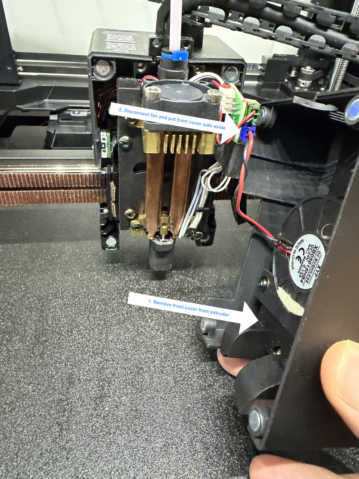 Remove the extruder's front cover, then disconnect the fan before setting it aside